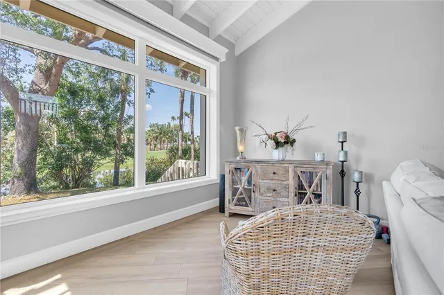 a bedroom with a bed and a large window with outer view