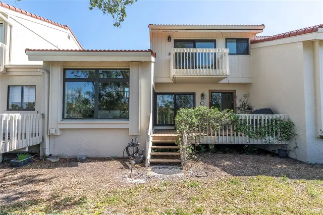 a view of a house with a deck and a yard