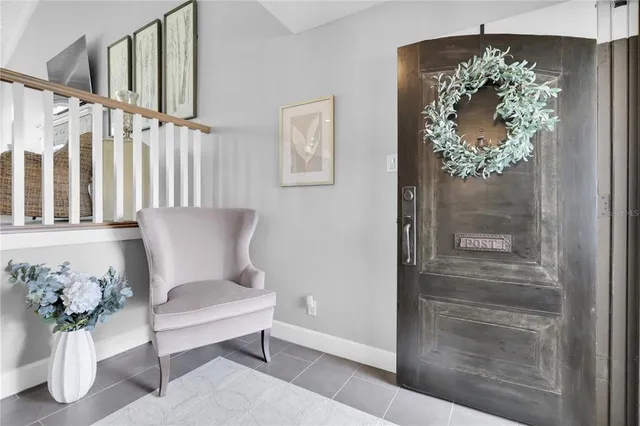a view of a hallway with wooden floor and a chandelier