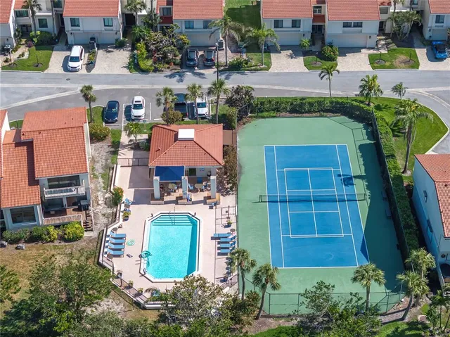 an aerial view of a house with a swimming pool outdoor seating and yard
