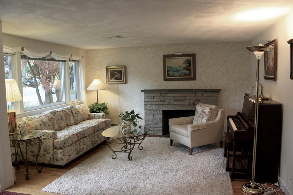 74 Yerxa Road Arlington, MA 02474 - Photo 2 of 16 a living room with furniture and a fireplace