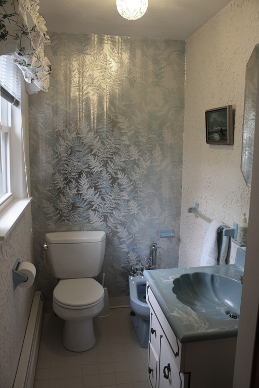 74 Yerxa Road Arlington, MA 02474 - Photo 7 of 16 a bathroom with a granite countertop toilet sink and mirror