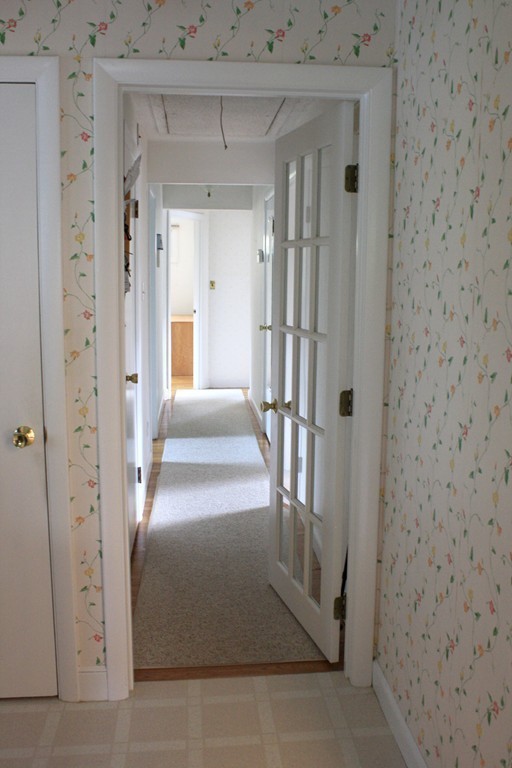 74 Yerxa Road Arlington, MA 02474 - Photo 8 of 16 a view of a hallway with wooden floor and staircase
