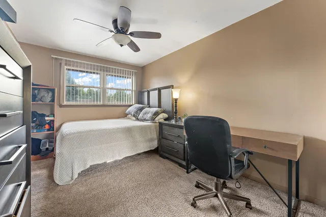 a bedroom with a bed and a table