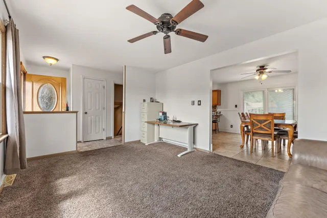 a view of a livingroom with furniture and a ceiling fan