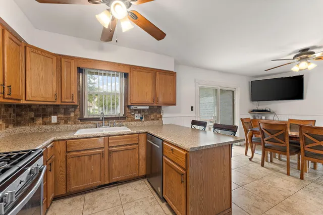 a kitchen with a stove window and cabinets