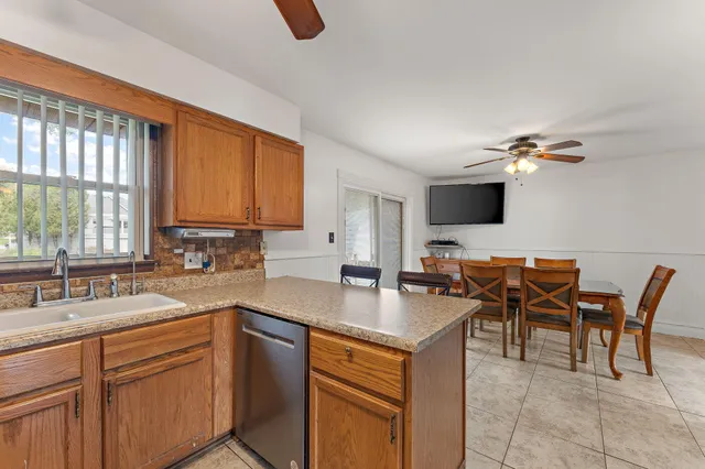 a kitchen with a sink cabinets and window