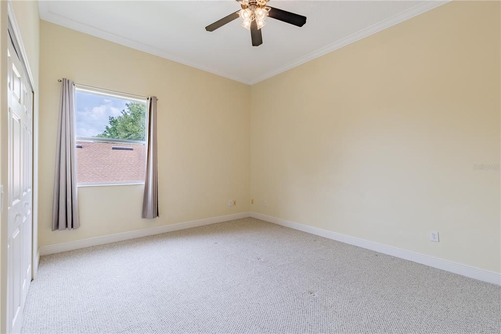 2718 Knightsbridge Road Clermont, FL 34711 - Photo 13 of 72 an empty room with a ceiling fan and carpet