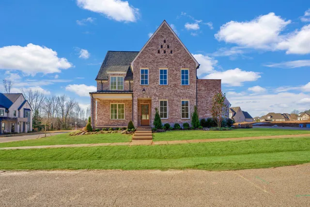 a front view of a house with a yard