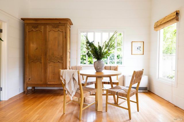 a dining room with furniture and wooden floor