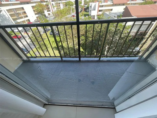 a view of a balcony with furniture
