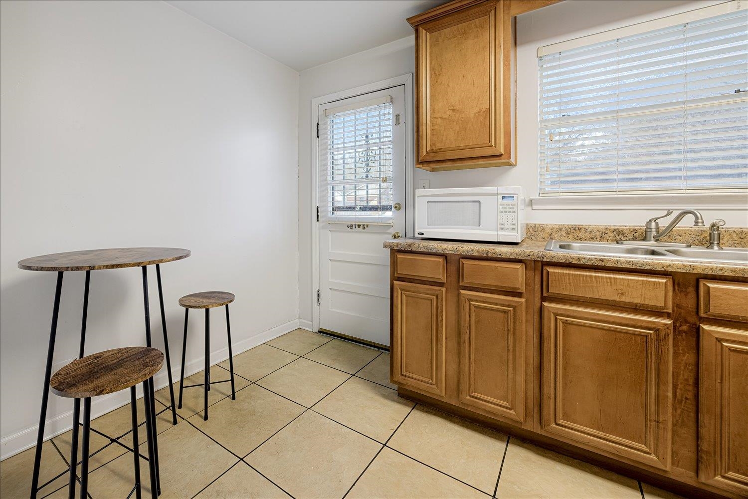 524 Mineral Road Memphis, TN 38120 - Photo 8 of 26 a kitchen with stainless steel appliances granite countertop a sink and a window