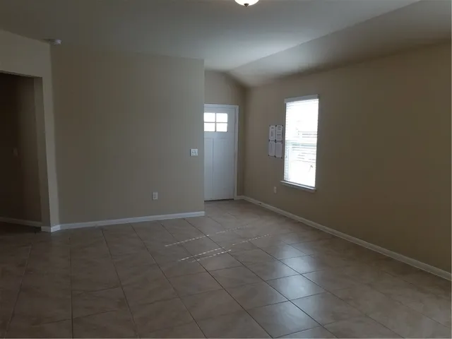 an empty room with windows and entrance