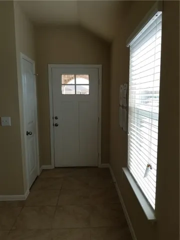 a view of an empty room and a window