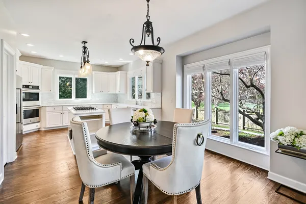 a view of a workspace room with furniture and window