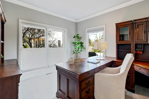 a living room with furniture and a floor to ceiling window