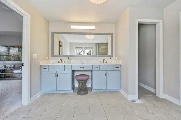 a bedroom with a bed next to a large window with the outer view