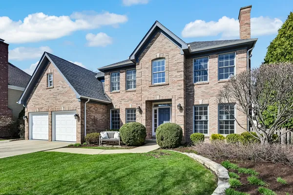 a view of a wooden bench in front of house