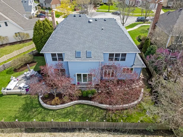a view of a house with backyard sitting area and garden