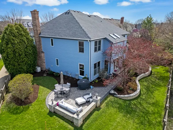 an aerial view of a house with a garden and lake view