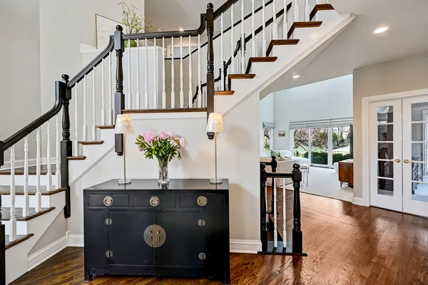 a dining room with furniture a chandelier and wooden floor