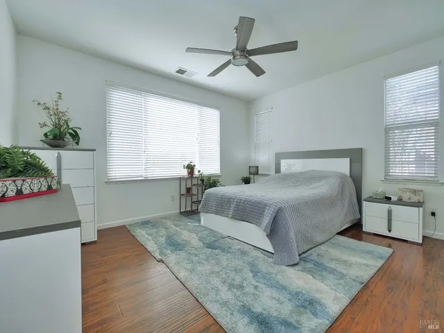 a bedroom with a large bed and a window