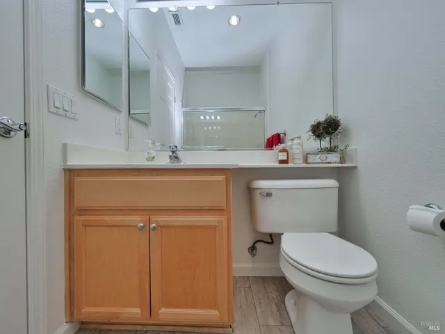 a bathroom with a toilet a sink and a mirror