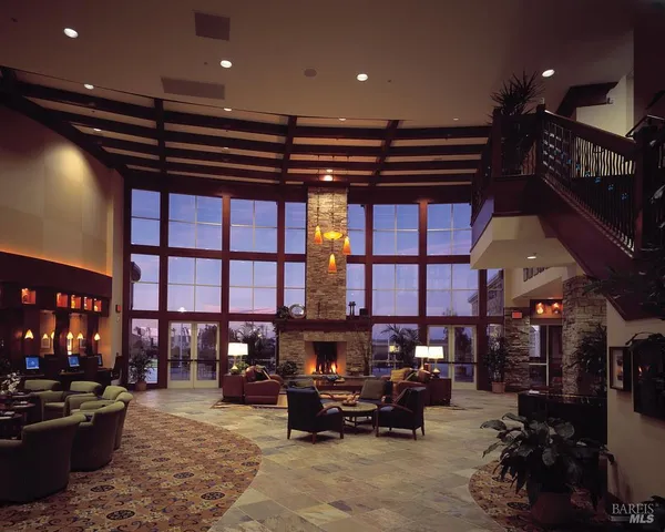 a living room with lots of furniture and a fireplace