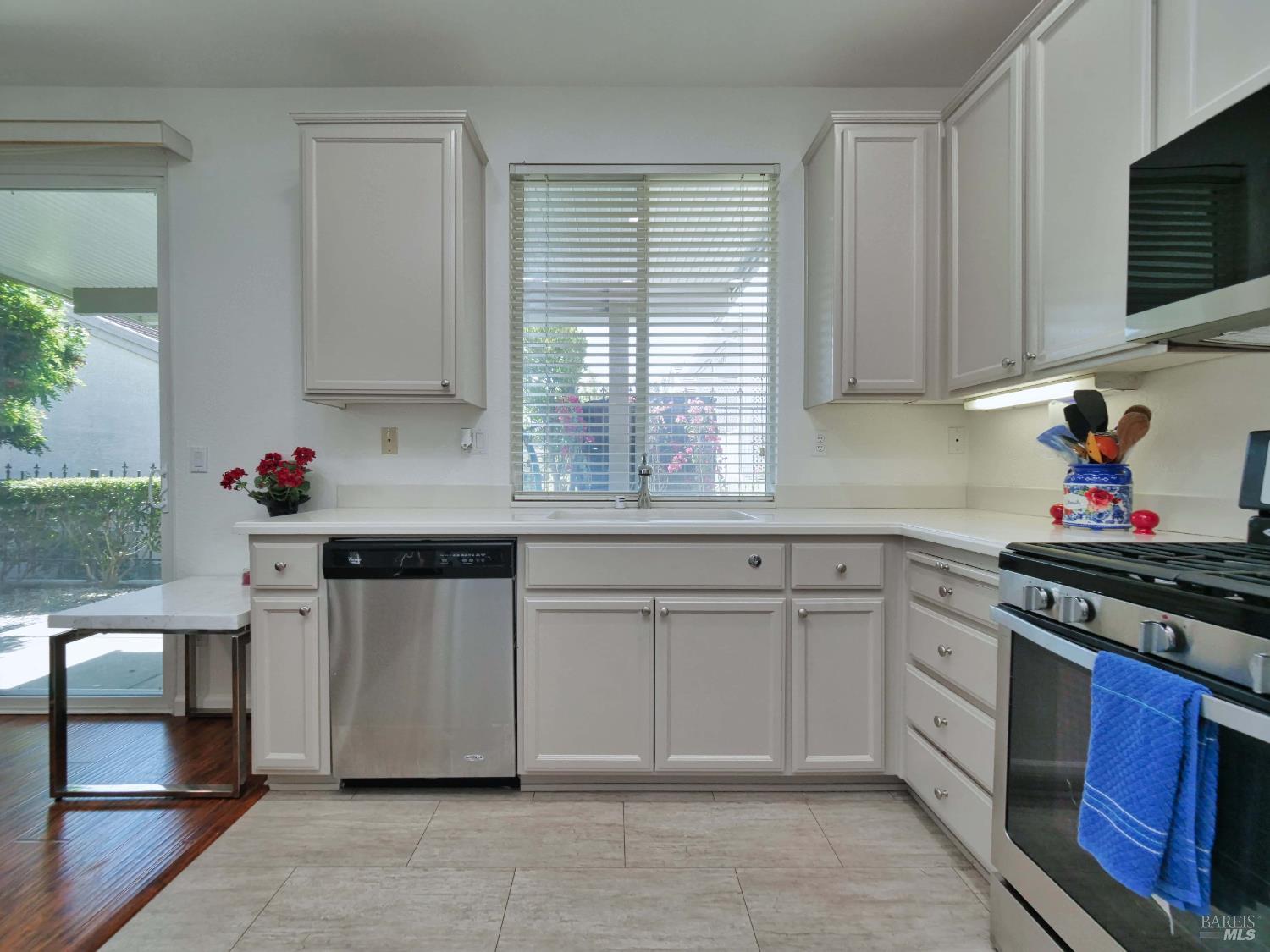 659 Pinehurst Drive, Unit CA Rio Vista, CA 94571 - Photo 9 of 40 a kitchen with stainless steel appliances granite countertop a stove sink and cabinets