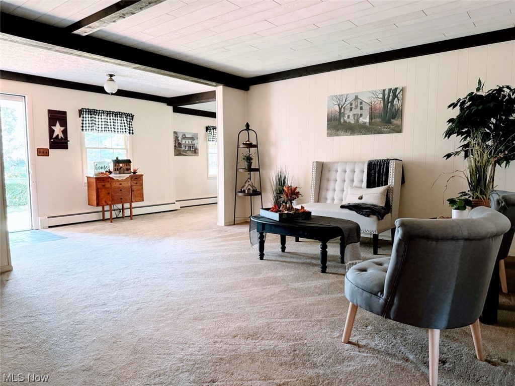 1639 Stonehaven Road Madison, OH 44057 - Photo 34 of 35 Living area with beamed ceiling, light colored carpet, and a baseboard heating unit