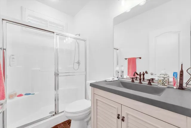 a bathroom with a sink toilet and shower