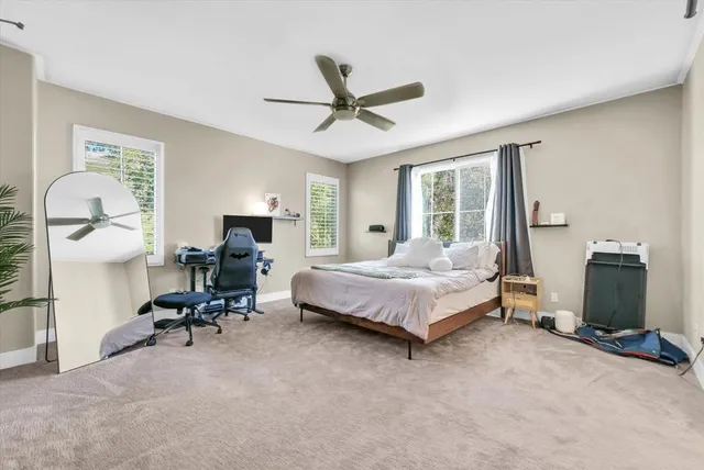 a bedroom with a bed gym equipment and a large window