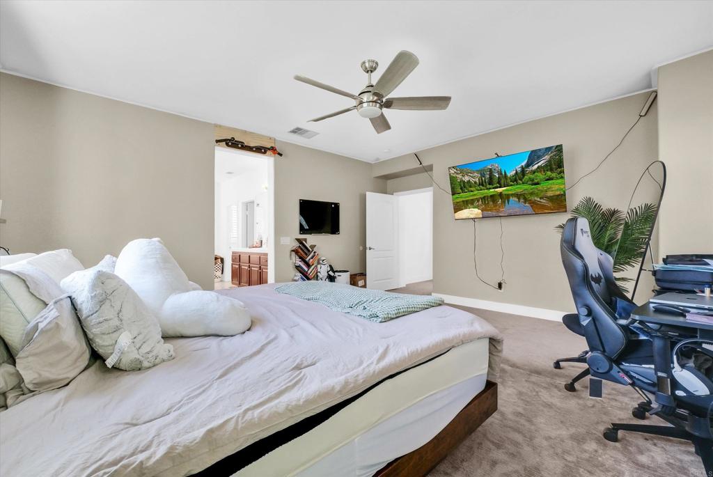 45418 Seagull Way Temecula, CA 92592 - Photo 16 of 31 a bedroom with a bed a computer on the desk and a book shelf