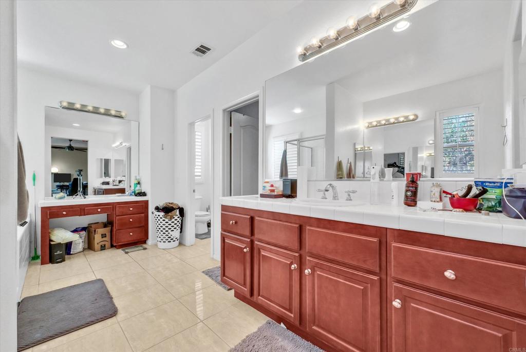 45418 Seagull Way Temecula, CA 92592 - Photo 17 of 31 a spacious en suite bathroom with double vanity and a mirror