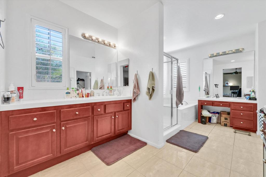 45418 Seagull Way Temecula, CA 92592 - Photo 18 of 31 a spacious bathroom with a tub sink and mirror
