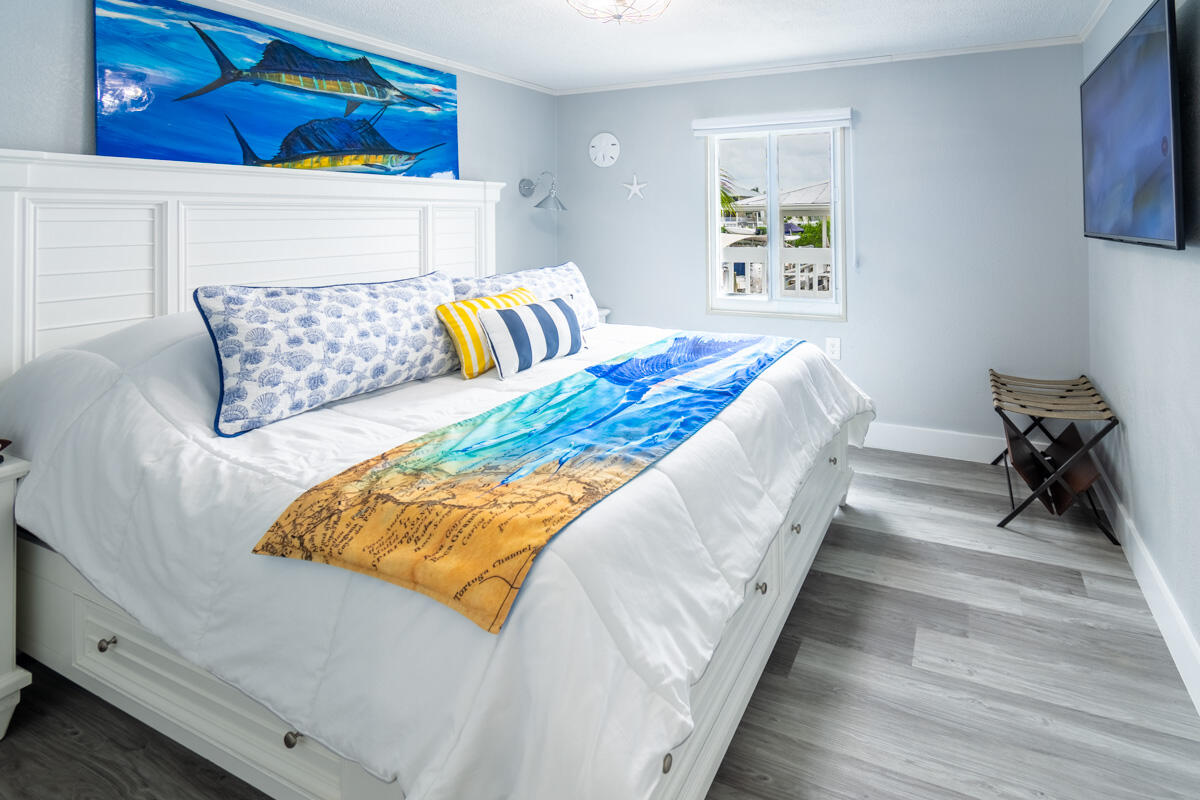 576 Coconut Avenue Goodland, FL 34140 - Photo 12 of 38 a bed sitting in a bedroom next to a small yard