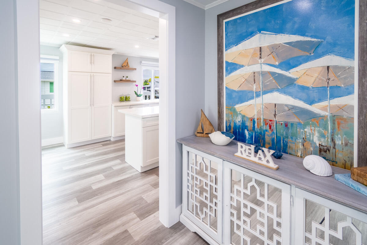 576 Coconut Avenue Goodland, FL 34140 - Photo 16 of 38 a dining room with furniture a chandelier and a rug