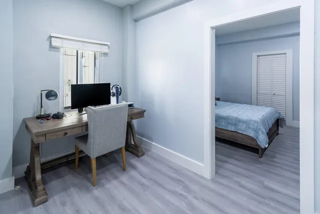 a view of a workspace with furniture and wooden floor