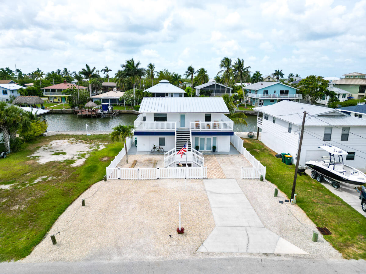 576 Coconut Avenue Goodland, FL 34140 - Photo 22 of 38 a view of a lake with a house in the background
