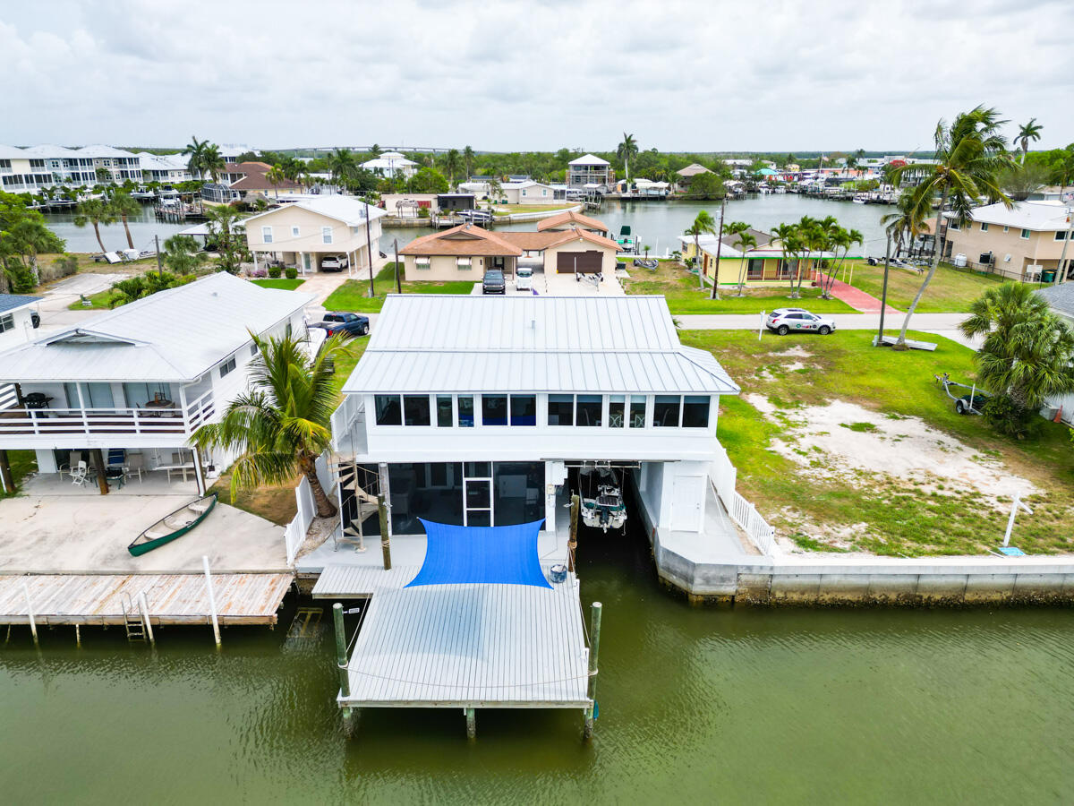 576 Coconut Avenue Goodland, FL 34140 - Photo 29 of 38 a aerial view of a house with swimming pool and large trees