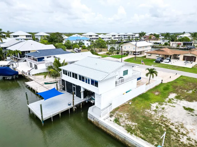 an aerial view of a house with lake view