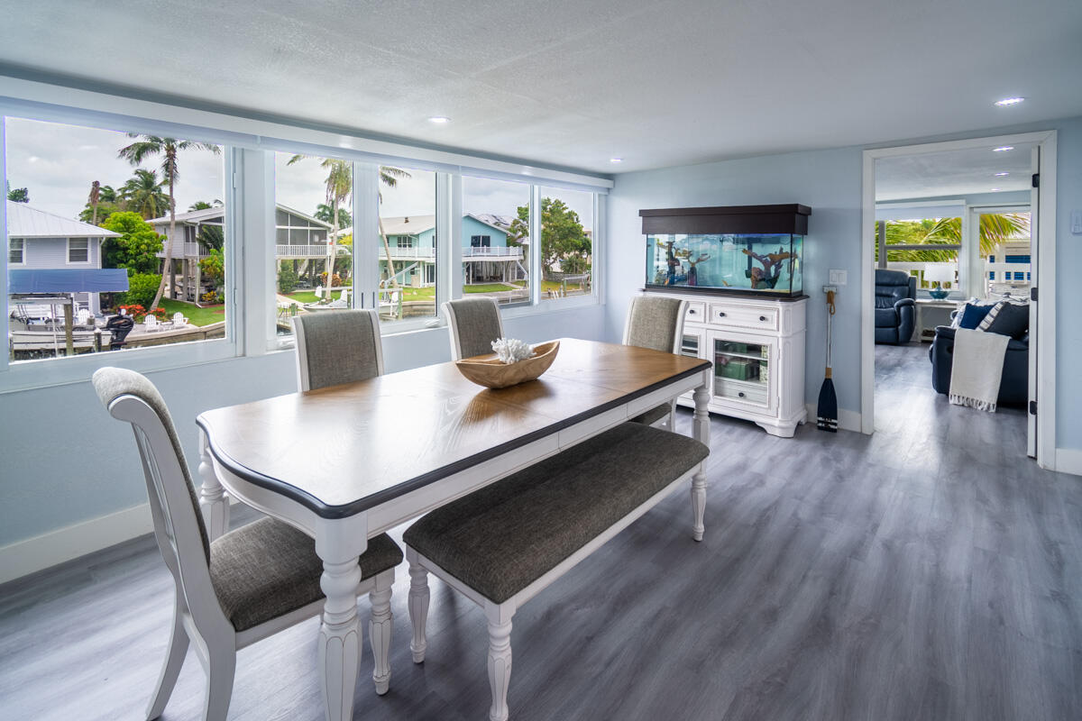576 Coconut Avenue Goodland, FL 34140 - Photo 5 of 38 a view of a dining room with furniture and wooden floor