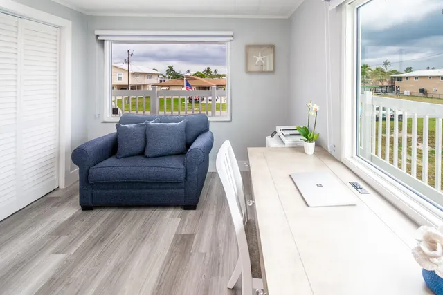 a living room with furniture and a floor to ceiling window