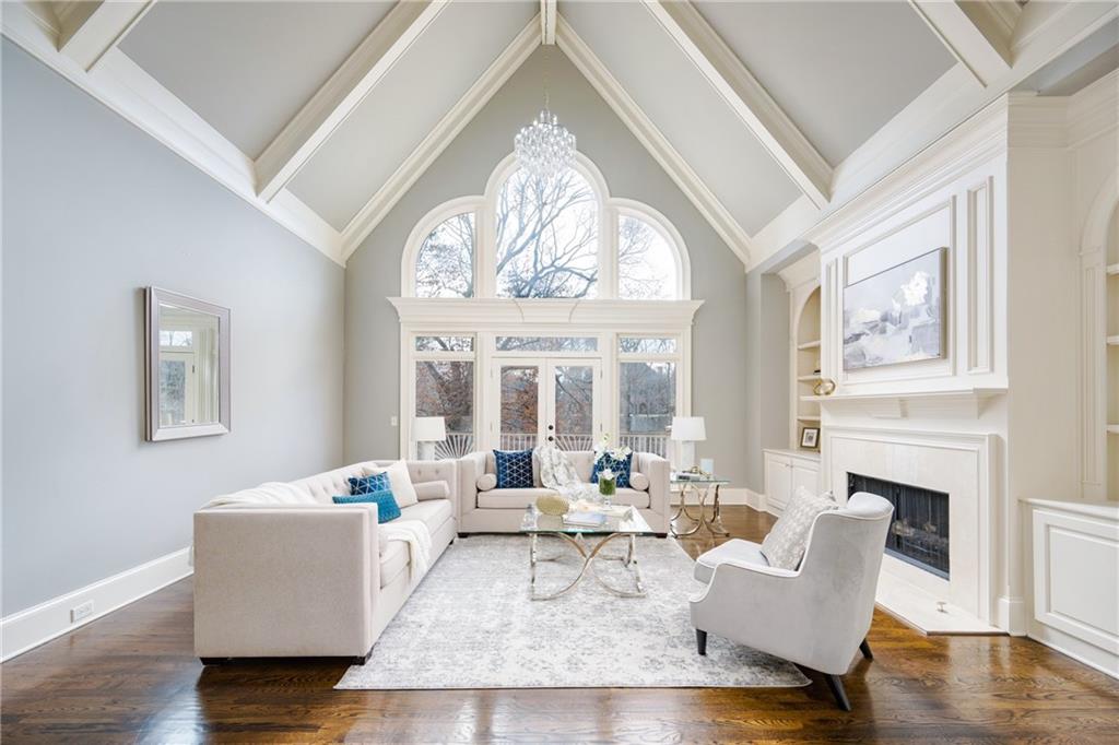 2760 Sugarloaf Club Drive Duluth, GA 30097 - Photo 14 of 67 a living room with furniture a fireplace and a large window