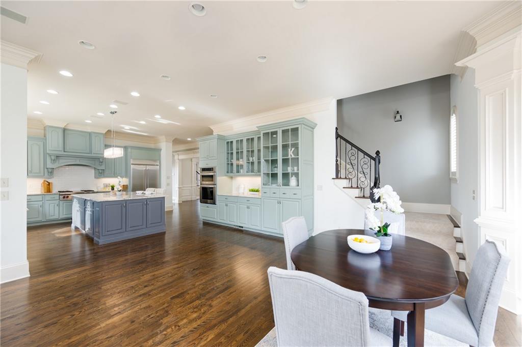 2760 Sugarloaf Club Drive Duluth, GA 30097 - Photo 18 of 67 a living room with kitchen island furniture and a wooden floor