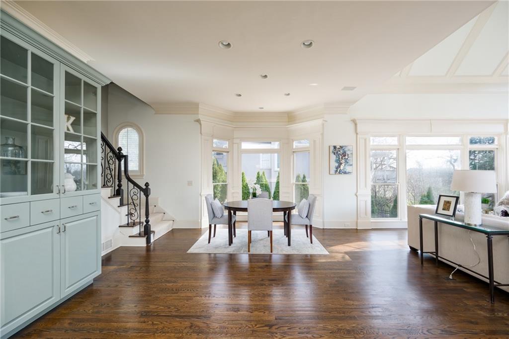 2760 Sugarloaf Club Drive Duluth, GA 30097 - Photo 19 of 67 a living room with furniture a wooden floor and a large window