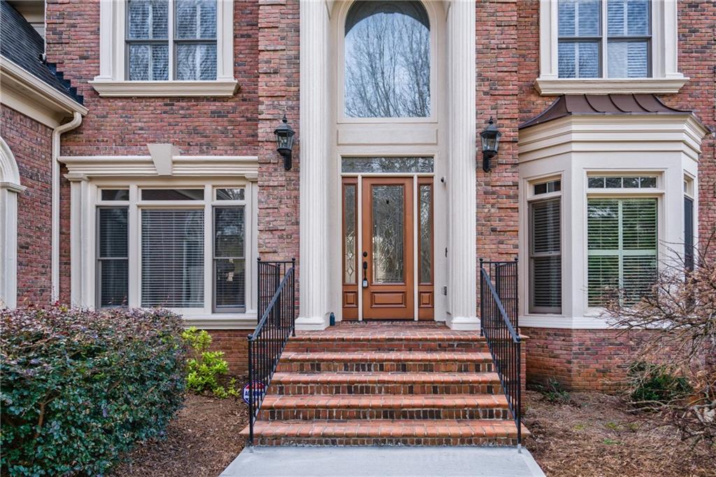 2760 Sugarloaf Club Drive Duluth, GA 30097 - Photo 2 of 67 a front view of a house with a garden