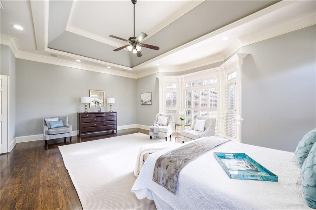 2760 Sugarloaf Club Drive Duluth, GA 30097 - Photo 28 of 67 a spacious bedroom with a bed and wooden floor