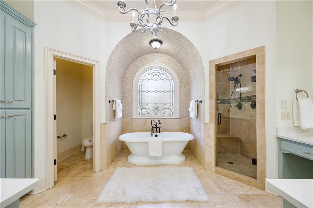 2760 Sugarloaf Club Drive Duluth, GA 30097 - Photo 31 of 67 a spacious bathroom with a bathtub shower sink and mirror