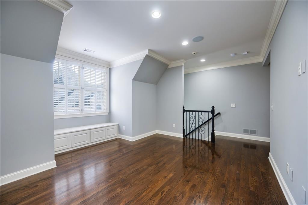 2760 Sugarloaf Club Drive Duluth, GA 30097 - Photo 35 of 67 a view of an empty room with wooden floor and a window